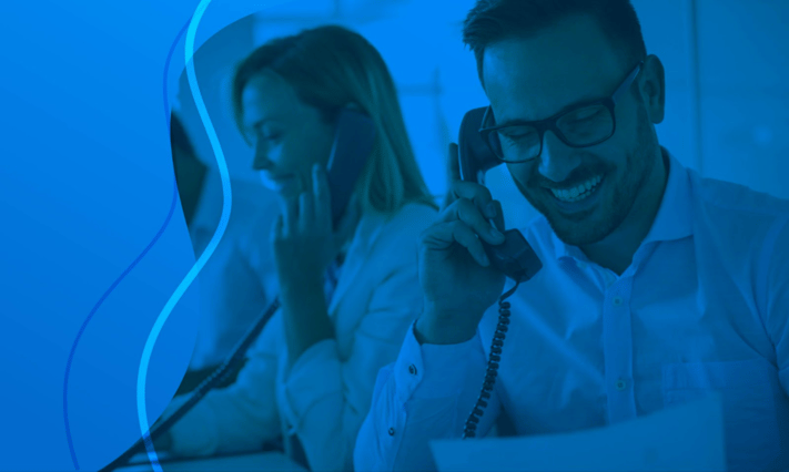 Man and woman speaking on the phone at work