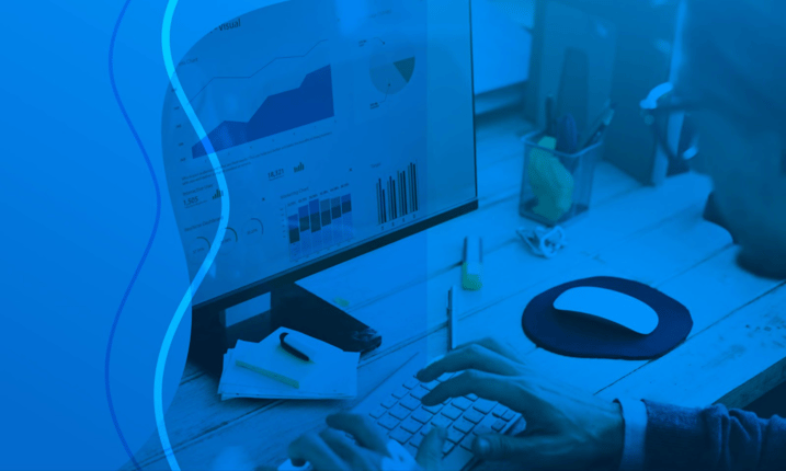 business person looking at stats on screen
