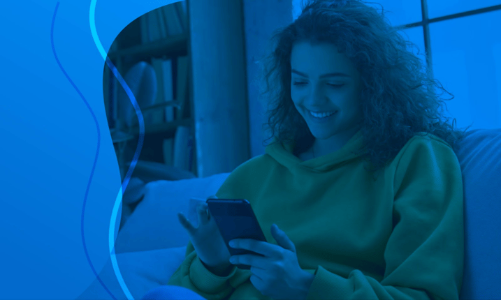 woman on couch looking at phone