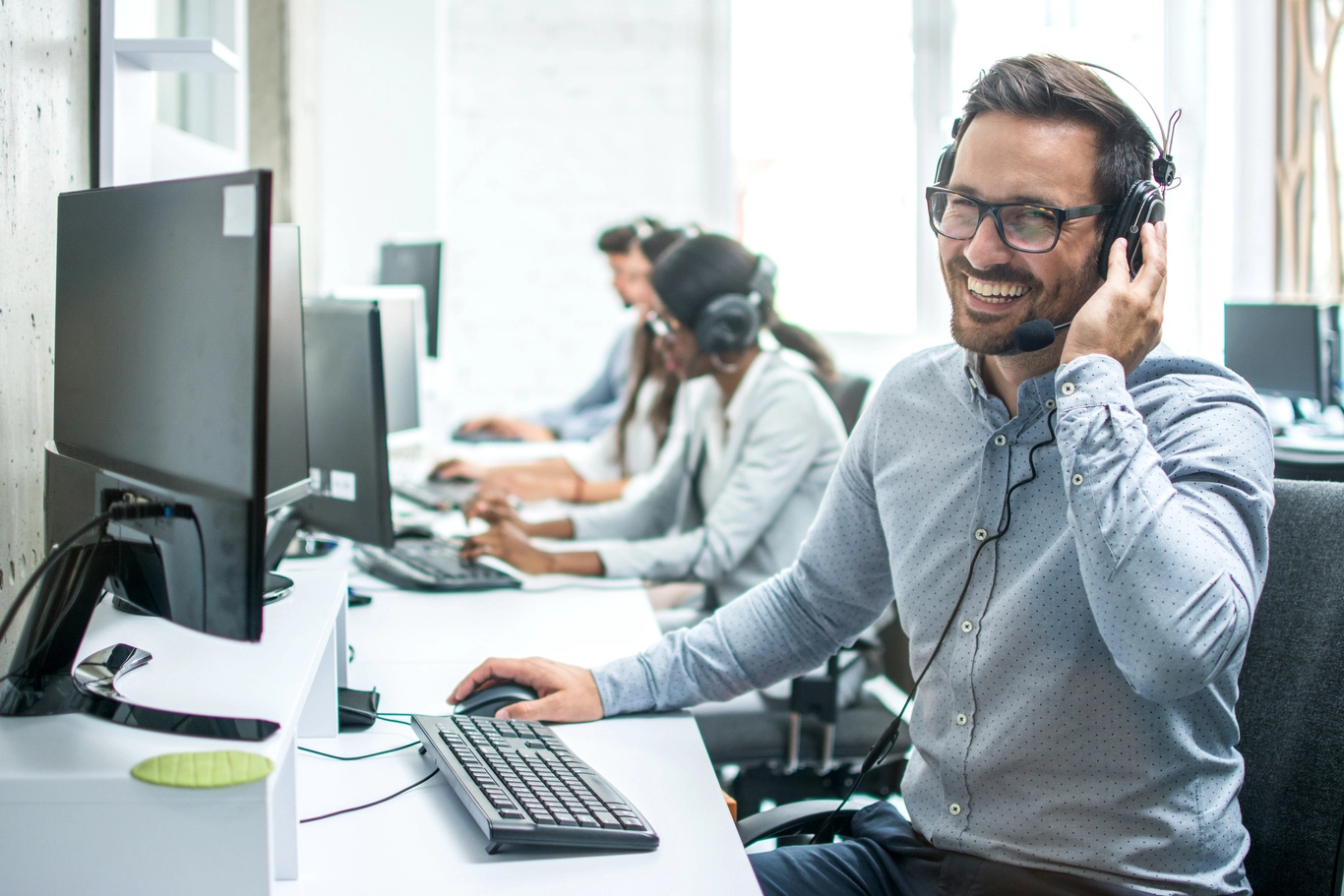 man-with-headset-and-others-looking-at-camera